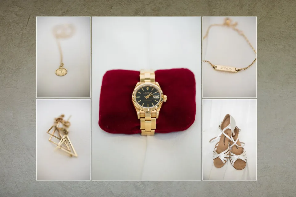 Close-up of the bride's watch, jewellery and rings on a red cushion
