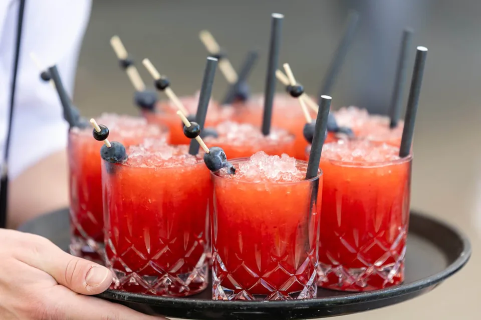 Tray of red welcome cocktails at the Fernblick