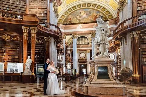 Wedding couple in the empty state hall of the Austrian National Library