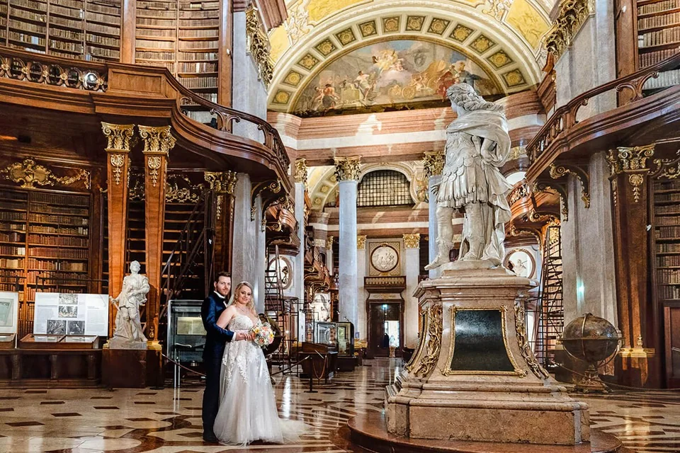 Wedding couple in the empty state hall of the Austrian National Library