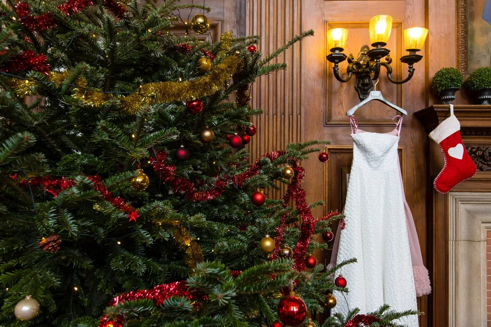 Wedding dress beside a decorated Christmas tree, winter wedding