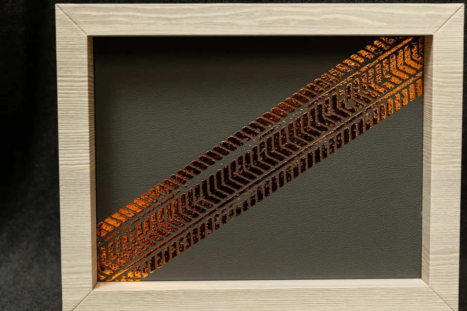 Copper-colored finish on the inside of the album's wooden box