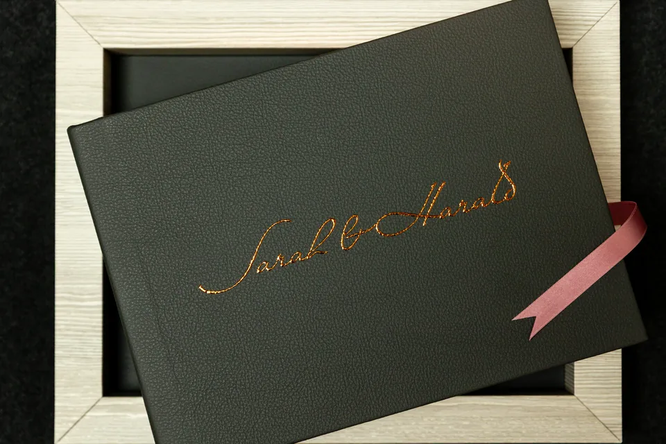 Milano wedding album in leather with gold name embossing and satin ribbon
