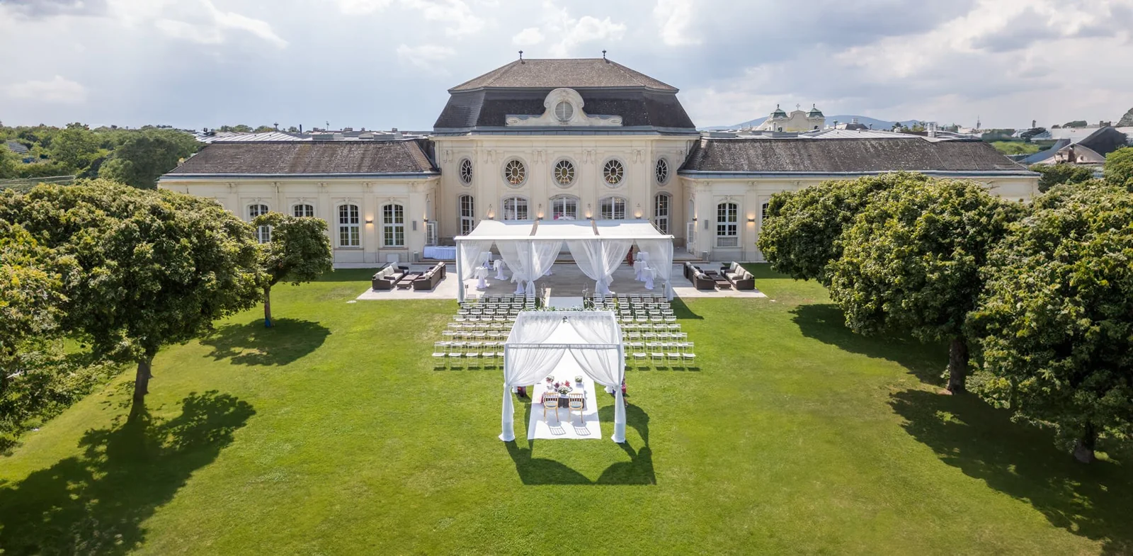 Open-air wedding ceremony in the gardens of the Conference Center at Laxenburg Castle, seen from above