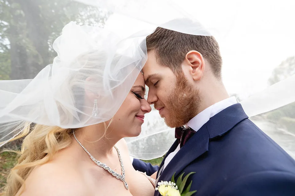 Hochzeitspaar hinter dem Brautschleier, Nahaufnahme