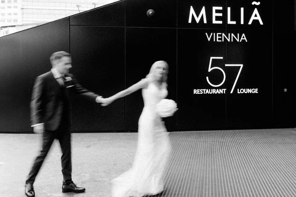 Playful wedding couple in an atmospheric black-and-white photograph