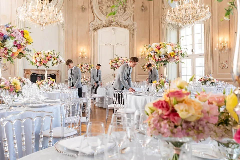 Setting up the wedding table with florals at Schloss Laxenburg