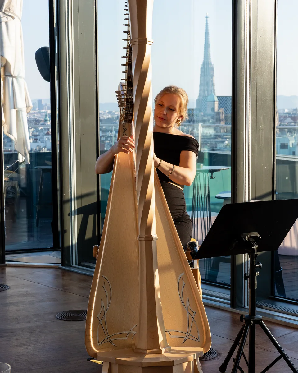 Concert harp in front of the window front at Juwel Vienna, St. Stephen's Cathedral behind