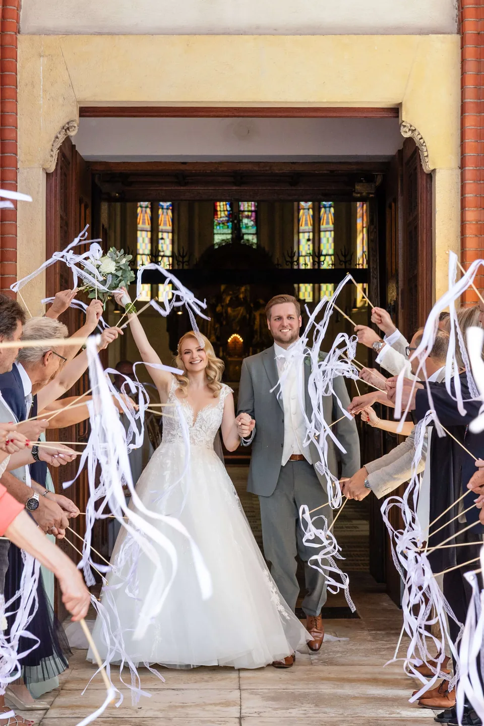Church exit with cheering guests and ribbons