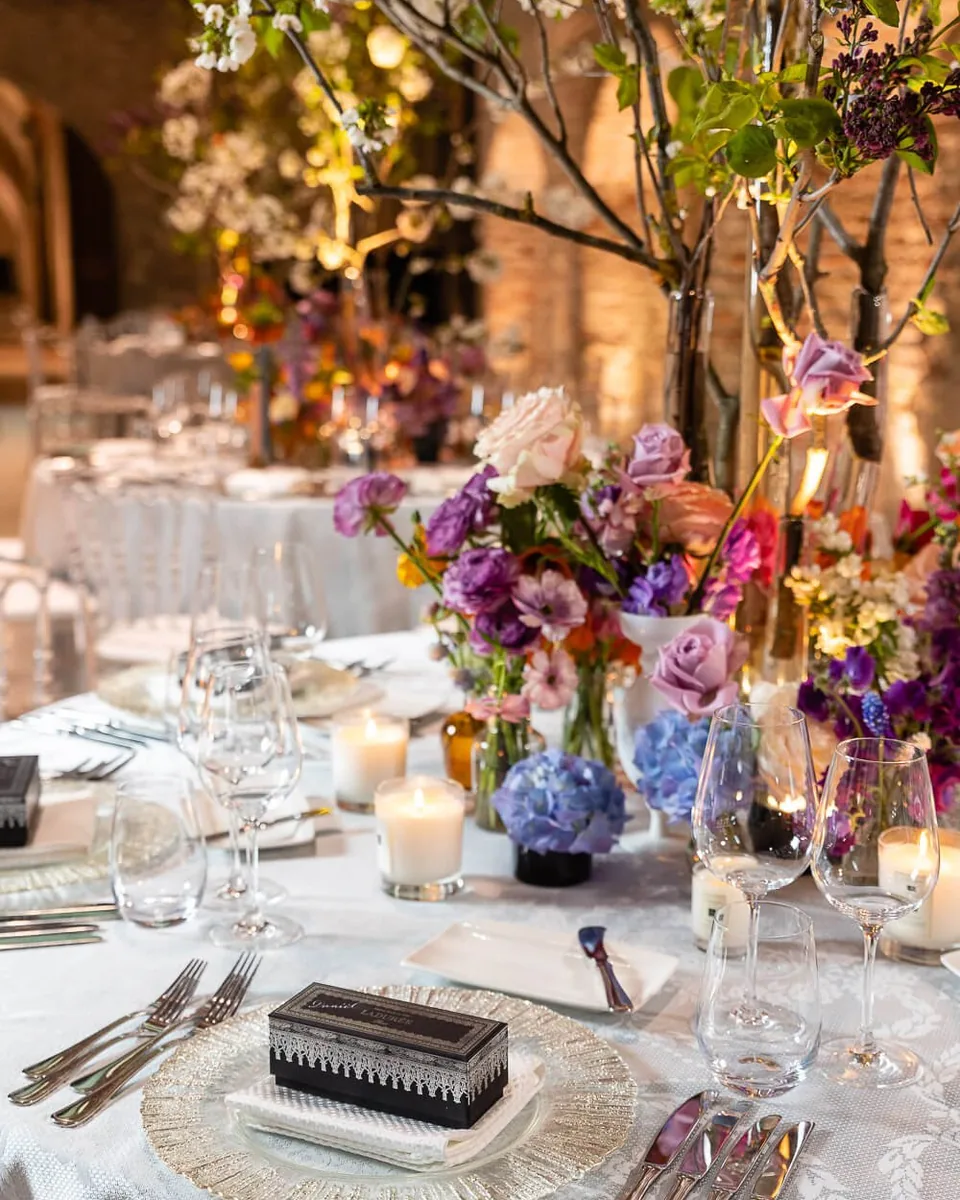 Festive place setting with colourful florals and fine pastries at Palais Coburg