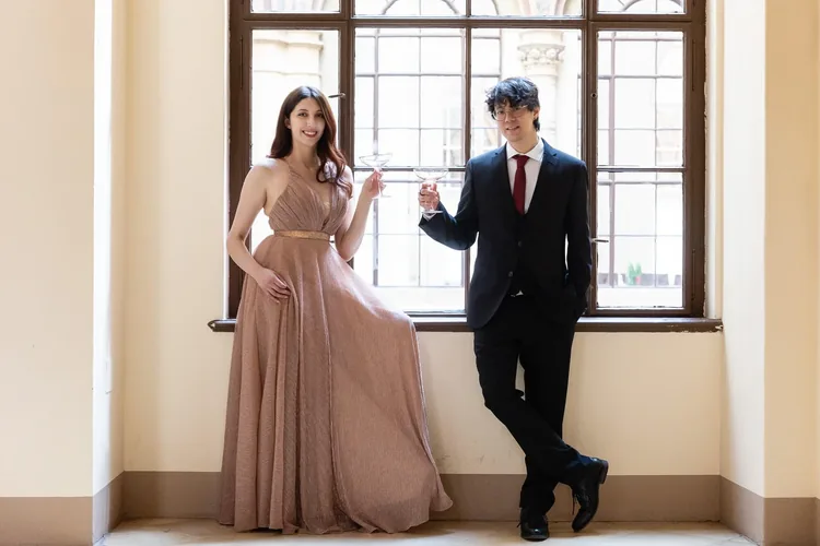 Elegant couple at the window of a Viennese palais
