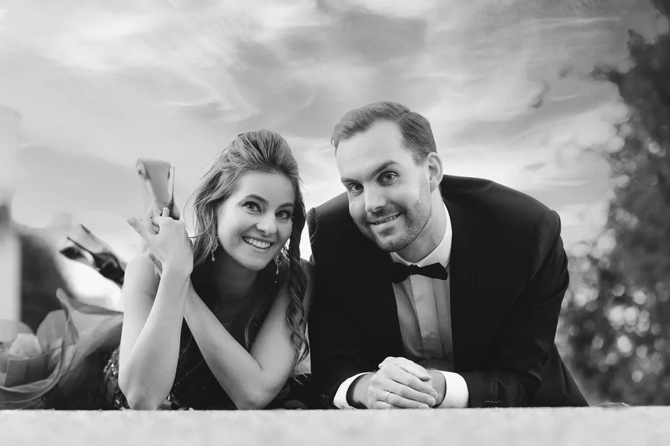 Laughing engaged couple in an elegant black-and-white photograph