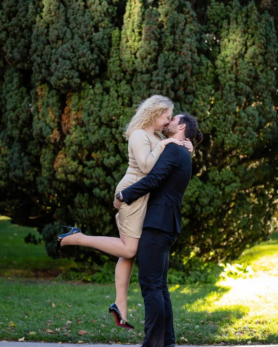 Couple in love, he lifts her laughing, in the Burggarten Vienna